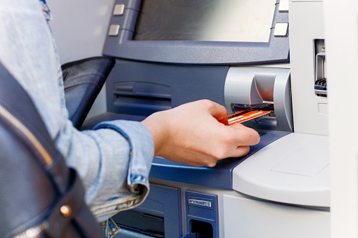 Hand inserting ATM credit card