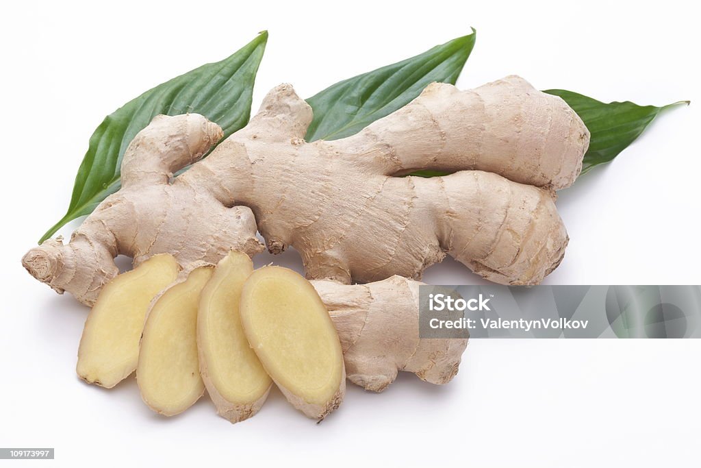 Fresh ginger with leaves on white background. Close-up Stock Photo