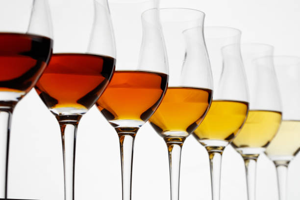 Row of cognac glasses with different stages of aging Row of cognac glasses with different stages of aging sherry stock pictures, royalty-free photos & images
