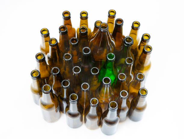 Person putting a glass bottle in a recycling container