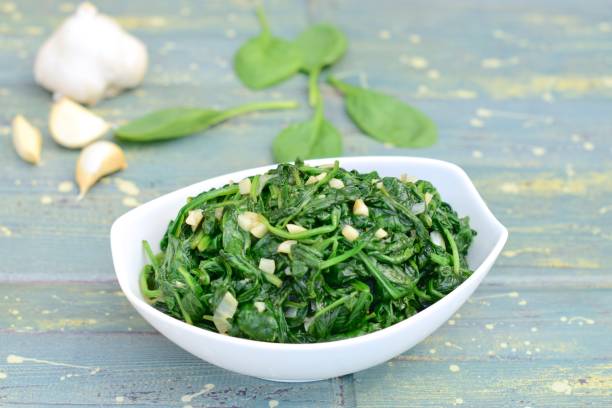 Healthy vegetarian food sautéed spinach garlic Healthy vegetarian food sautéed spinach garlic sauteed stock pictures, royalty-free photos & images