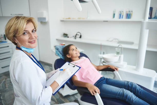 istock Smiling dentist is making diagnosis for young lady 1091756356