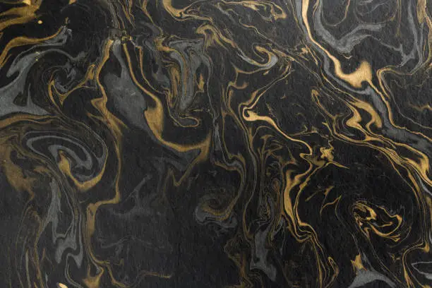Photo of marble ink paper texture black grey gold