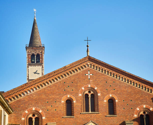 Detail of the main facade of the Basilica of Saint Eustorgio. View from Piazza Sant'Eustorgio square. Milan, Lombardy, Italy.