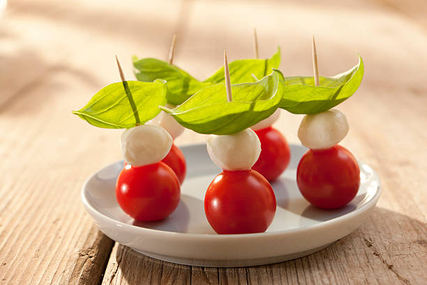 Caprese salad / Tomatoes, mozzarella and basil stock photo