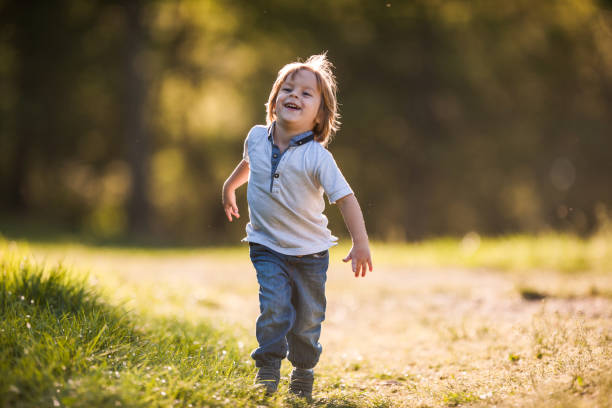 istock Cute happy kid running in the park. 1091764318