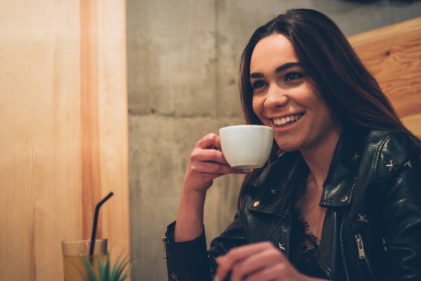 istock Cute girl drinks coffee in cafe 1091764634