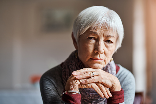 Shot of a senior woman looking sad in a retirement home