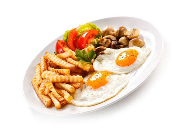 istock Fried eggs, French fries and vegetables 1091764846
