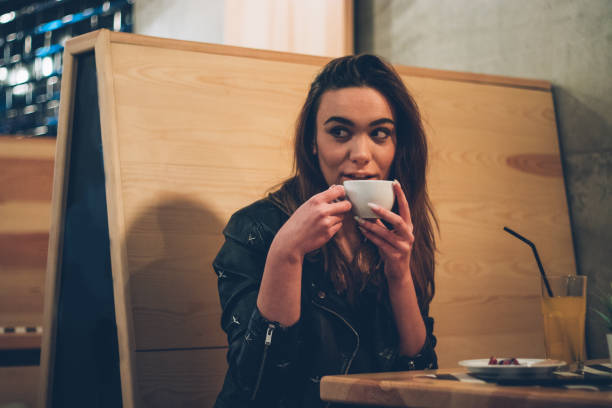 istock Beautiful young woman drinks coffee and juice 1091766832