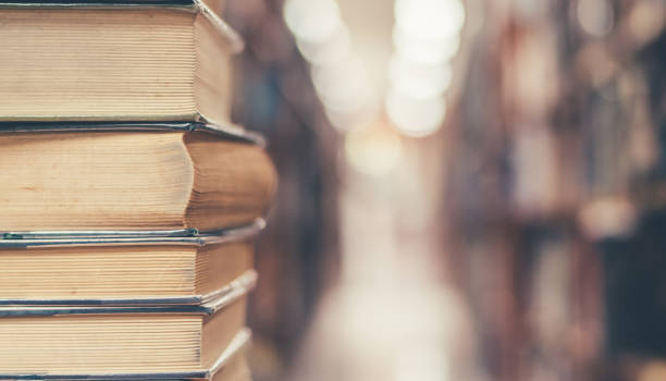 istock Book stack in library study room with bookshelf for business and education background, class learning and back to school concept 1091773432