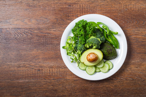 istock green vegetables ingredients on white plate top view 1091777304