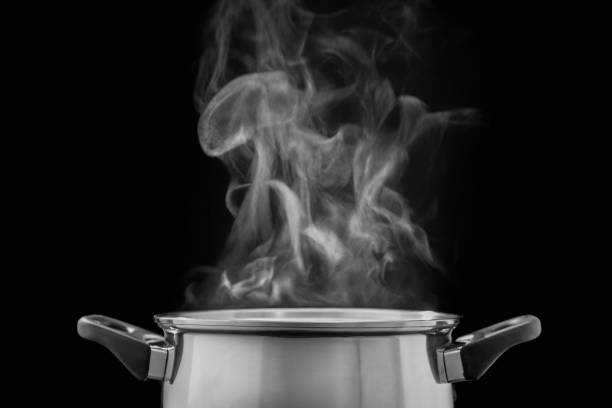 istock steam over cooking pot in kitchen on dark background 1091780442