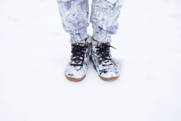istock shoes covered by snow in the winter. 1091782196