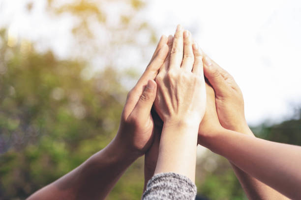 istock People hands assemble as a connection meeting teamwork concept. Group of people assembly hands as a business or work achievement, hit target or goal.Collaboration Business Team success concept 1091782538