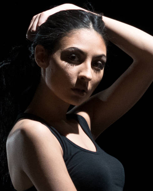 istock Beautiful female standing in the dark 1091784744