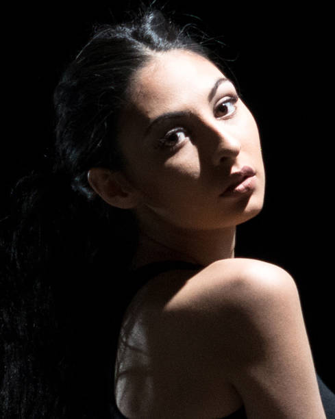 istock Beautiful female standing in the dark 1091784746