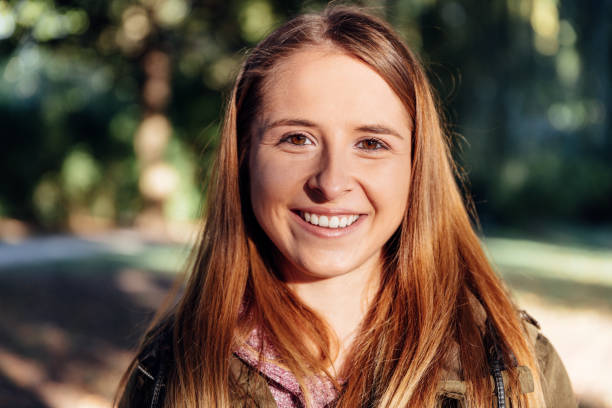 istock Caucasian female looking at camera in the park 1091784812