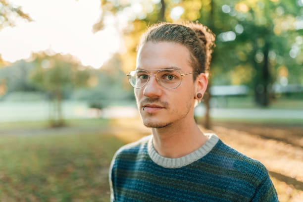 istock Pierced young guy in the park 1091785702