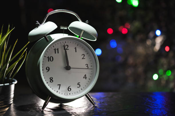 istock Alarm clock show before midnight for Christmas or New year and blur light background 1091787964