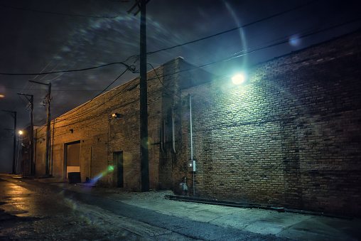 Dark and eerie industrial urban city street at night in Chicago