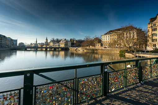 many different color and style locks and the wire railing of a bridge symbolizing long relationships and everlasting romantic love