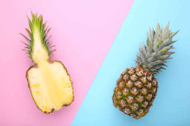 istock Pineapple and half of pineapple on a colorful background 1091806808