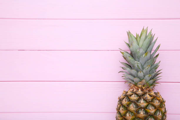 istock Ripe pineapple on a pink background with copy space 1091807260