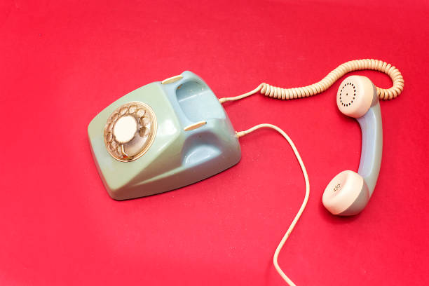 istock old retro phone isolated on red, pink background 1091810054