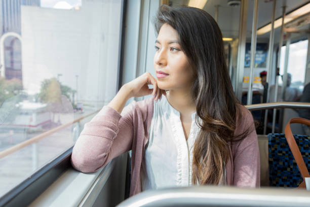 istock Reflective woman rides commuter train 1091812806