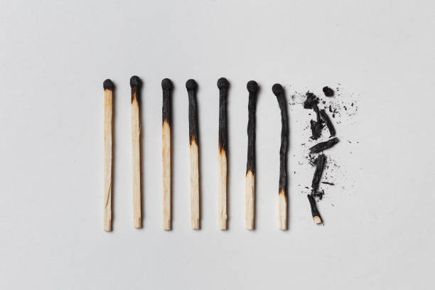 Concept of patience. A row of burnt matches, from left to right, from almost a whole match to a completely burnt match to the dust. Concept of patience. A row of burnt matches, from left to right, from almost a whole match to a completely burnt match to the dust. White background, flat lay. lit match stock pictures, royalty-free photos & images