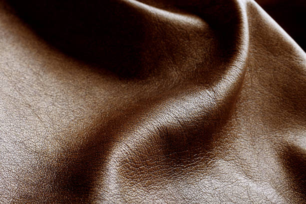 A brown genuine leather with some wrinkles Close-up photo of brown leather ripples cowhide stock pictures, royalty-free photos & images