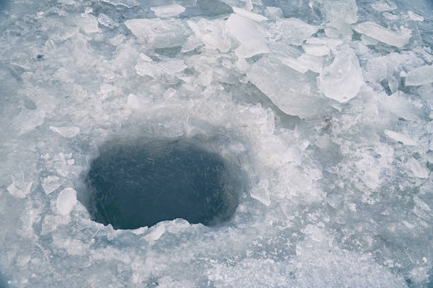 istock Ice hole in ice for winter fishing 1091822564