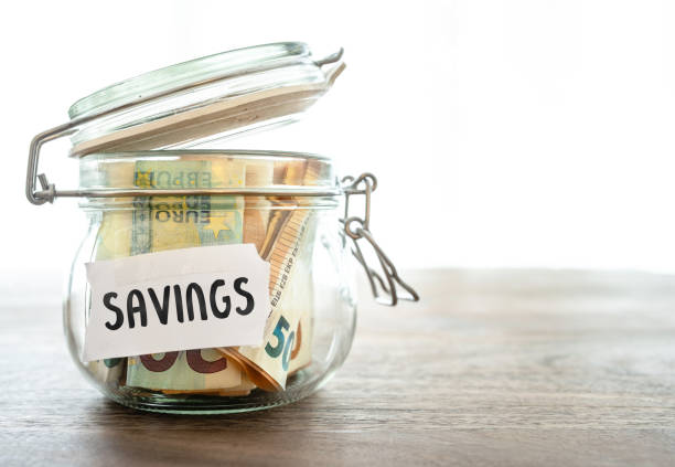 istock cash in jar labeled savings on wooden table 1091827532