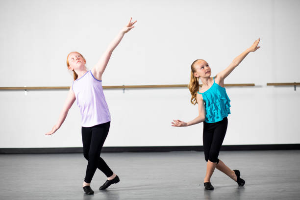 Young Girls Practicing Musical Theatre Dance in Studio Young girls practice their musical theatre and ballet in the dance studio jazz dancing stock pictures, royalty-free photos & images