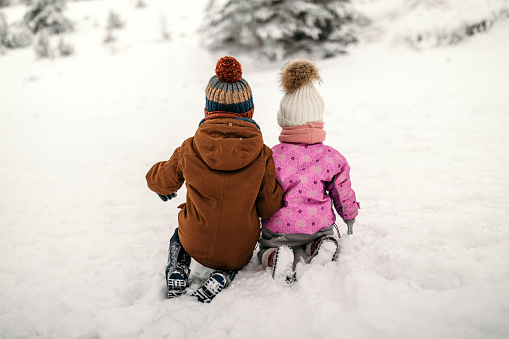 Lovely kids playing in snow together