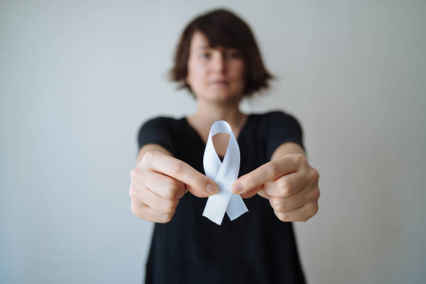 istock Young woman with white awareness ribbon 1091830538