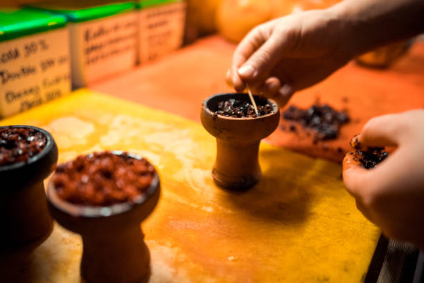 istock A man prepare hookah sisha in hookah art bar. Tabaco preparation. 1091831136