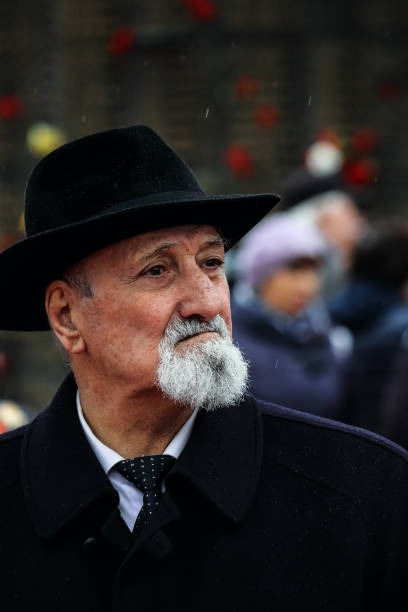 istock A white man with a gray beard in a black hat and coat is looking pensively to the side. 1091833722