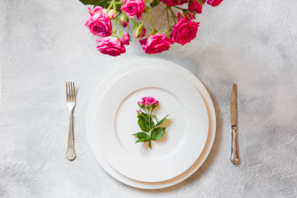istock Romantic table setting with bouquet of pink roses, and decorations. Top view. 1091838170