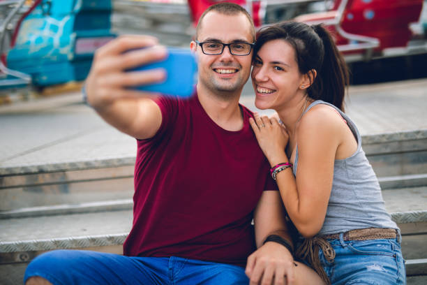 istock Couple making selfie in amusement park 1091839062