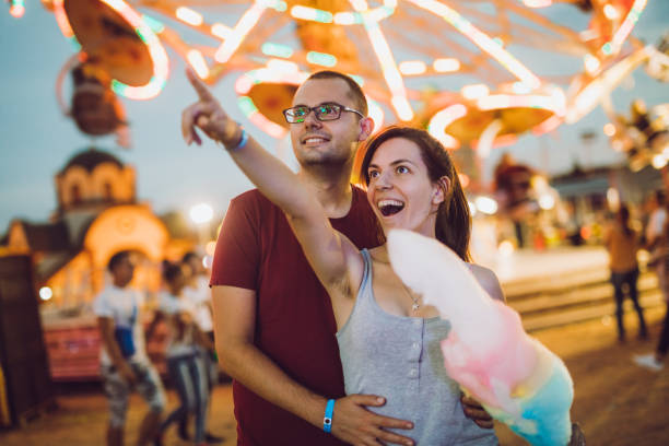 istock Young couple in amusement park 1091841806