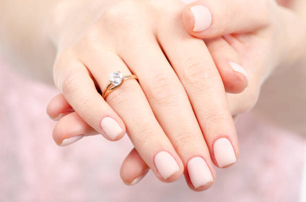 Woman hand a ring of gold silver beauty blur bckground