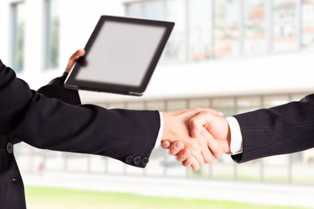 istock TWO businessman handshake with modern skyscrapers as background 1091846882