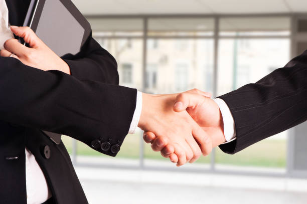 istock TWO businessman handshake with modern skyscrapers as background 1091846920