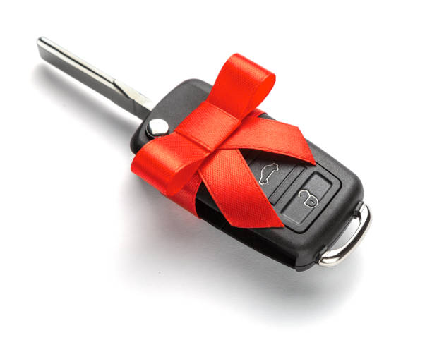 istock Gift Car keys with remote control alarm with red ribbon with bow. Isolated on white background. 1091852056