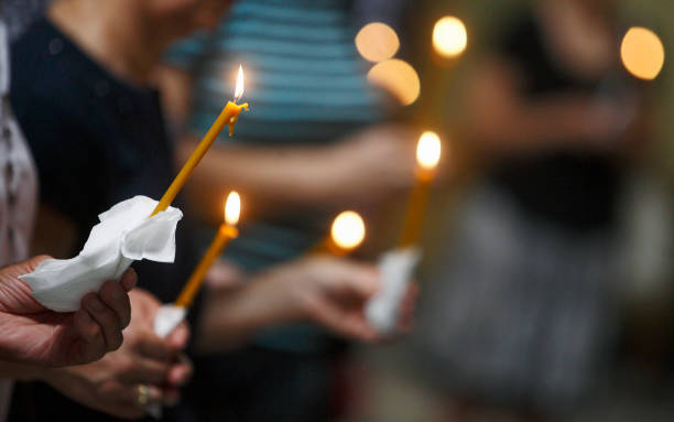 istock People holding candles in a church 1091855200