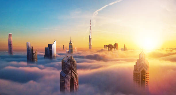 Dubai sunset view of downtown covered with clouds Dubai sunset panoramic view of downtown covered with clouds. Dubai is super modern city of UAE, cosmopolitan megalopolis. Very high resolution image dubai skyline stock pictures, royalty-free photos & images