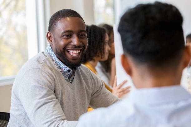 istock Young businessman enjoys discussion with partner during meeting 1091866110