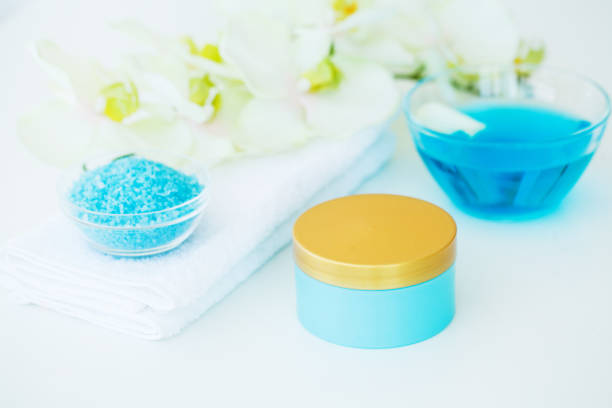 istock Blue Bath Salt, Body Cream and Shells For Spa on White Table Background 1091866826